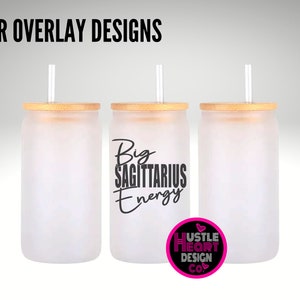 May include: Three frosted glass tumblers with bamboo lids and straws. The middle tumbler has the text "Big Sagittarius Energy" in black lettering. The tumblers are on a gray background.