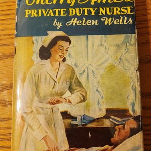 May include: Vintage book cover for "Cherry Ames, Private Duty Nurse" by Helen Wells. The cover art depicts a nurse in a white uniform attending to a patient in bed. The title is in yellow and the author's name is in white.