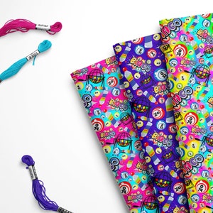 May include: Four different fabric swatches with a colorful bingo themed pattern. The pattern includes bingo balls, bingo cages, and the word "bingo" repeated throughout. The fabric swatches are pink, blue, purple, and turquoise.