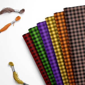 May include: A collection of six folded fabric swatches featuring a black gingham check pattern in red, green, purple, yellow, orange, and brown, accompanied by three loose embroidery floss skeins in brown, orange, and yellow colors.