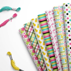 May include: A collection of eight different patterned fabric swatches featuring tropical themes. The patterns include pineapples, flamingos, polka dots, and text that says "happy", "relax", "vacation", "sun", "sweet", "shine", and "paradise".