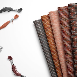 May include: Assortment of six brick patterned fabric swatches in various shades of red, brown, and gray. The fabric swatches are arranged in a fan shape. Two spools of embroidery floss, one orange and one gray, are also included.