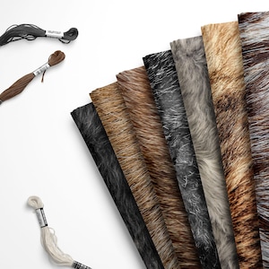 May include: A collection of nine rectangular fabric swatches featuring various faux fur textures in shades of black, brown, gray, white, and tan, arranged in a fan pattern alongside three skeins of embroidery floss in black, brown, and white.