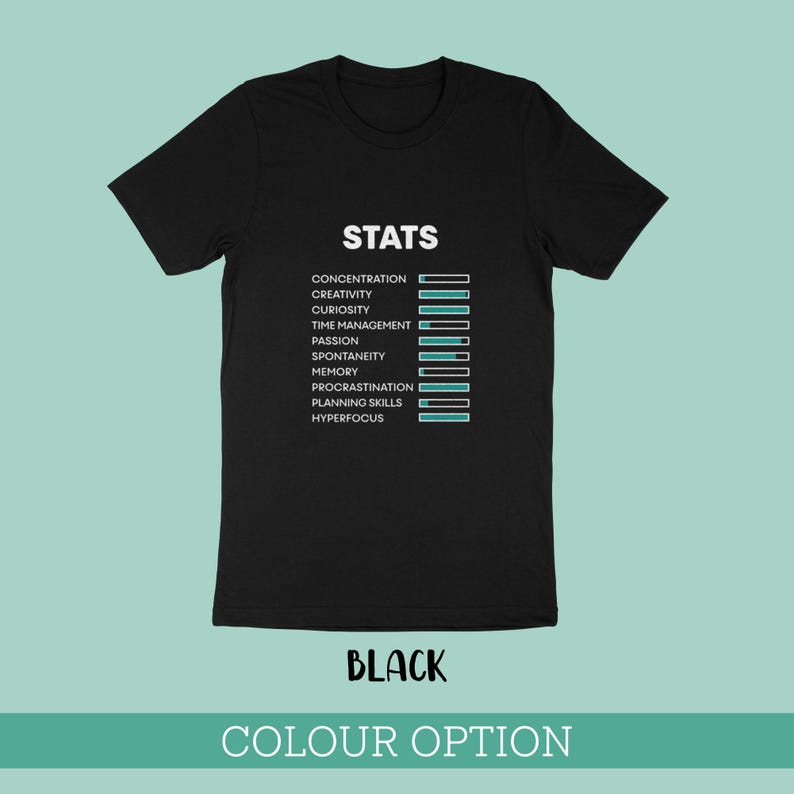 May include: A black short-sleeved t-shirt featuring the white text STATS at the top, followed by a list of attributes including concentration, creativity, curiosity, time management, passion, spontaneity, memory, procrastination, planning skills, and hyperfocus, each paired with a horizontal progress bar.