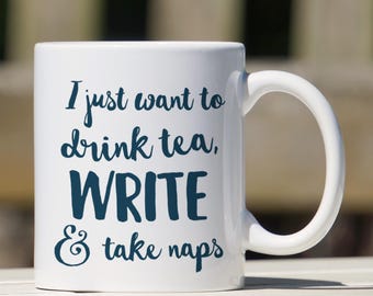 May include: White ceramic mug with a blue inscription that reads "I just want to drink tea, WRITE & take naps".