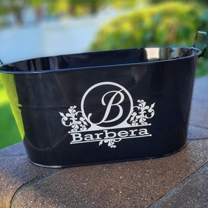 May include: Black metal ice bucket with a white monogram design featuring the letter "B" and the name "Barbera".