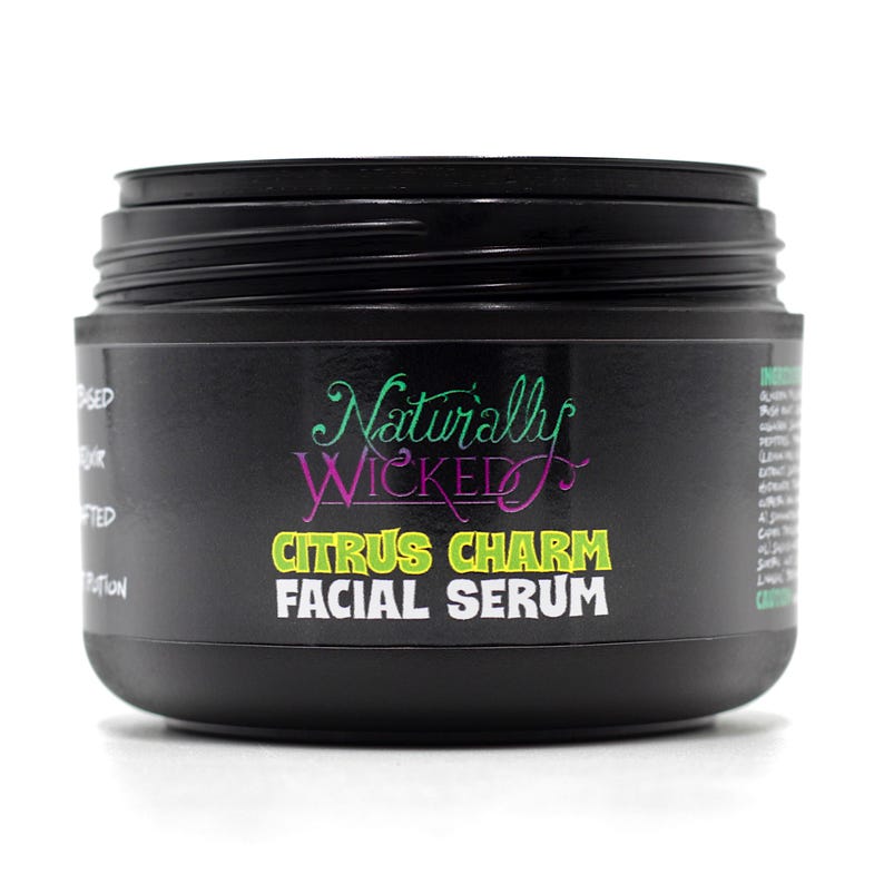 Naturally Wicked Citrus Charm Facial Serum jar with lid removed, ready to use.