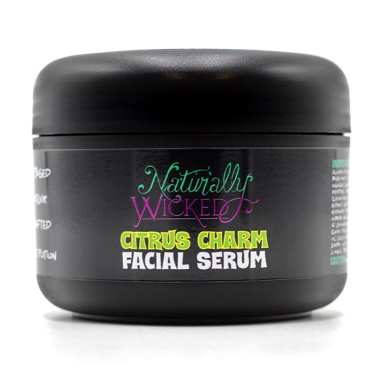 Naturally Wicked Citrus Charm Facial Serum in a sleek black jar with bold neon lettering. A handcrafted potion designed to bring a fresh, zesty glow to your skin