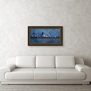 May include: A framed artwork featuring a row of bluebirds perched on a wooden branch against a dark blue background. The birds vary in shades of blue and white. The artwork is displayed on a white wall above a white sofa.