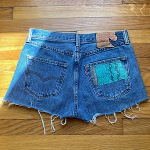 Vintage Levis Cutoffs with hand sewn patches / size small / size 27