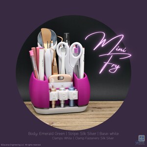 May include: A magenta and white organizer filled with craft tools, including scissors, pens, and tweezers. The organizer has a base with three labeled compartments. The text "Mini Fry" is displayed in a neon style.