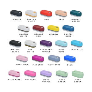 May include: A collection of small, rectangular crafting machines in various colors, including black, white, red, and green. Each machine has a rounded top and a contrasting colored base. Text labels identify each color, such as "Carbon" and "Rose Pink."