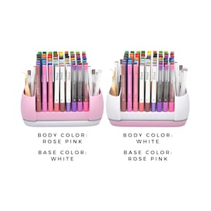 May include: Two pen organisers, one rose pink and one white, each filled with colourful pens and markers. The text on the image reads "BODY COLOUR: ROSE PINK, BASE COLOUR: WHITE" and "BODY COLOUR: WHITE, BASE COLOUR: ROSE PINK".