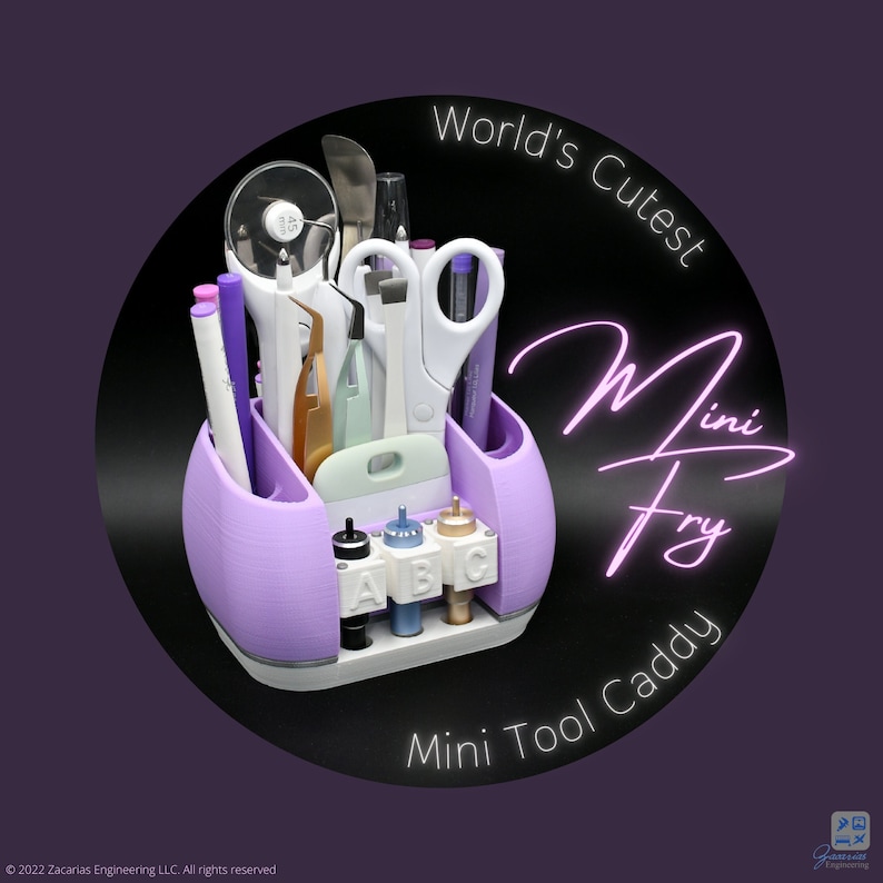 May include: A lavender and white Mini Tool Caddy, holding various craft tools like scissors, pens, and tweezers. The caddy has multiple compartments and a base for small bottles. Text on the image reads "World's Cutest Mini Fry Mini Tool Caddy."
