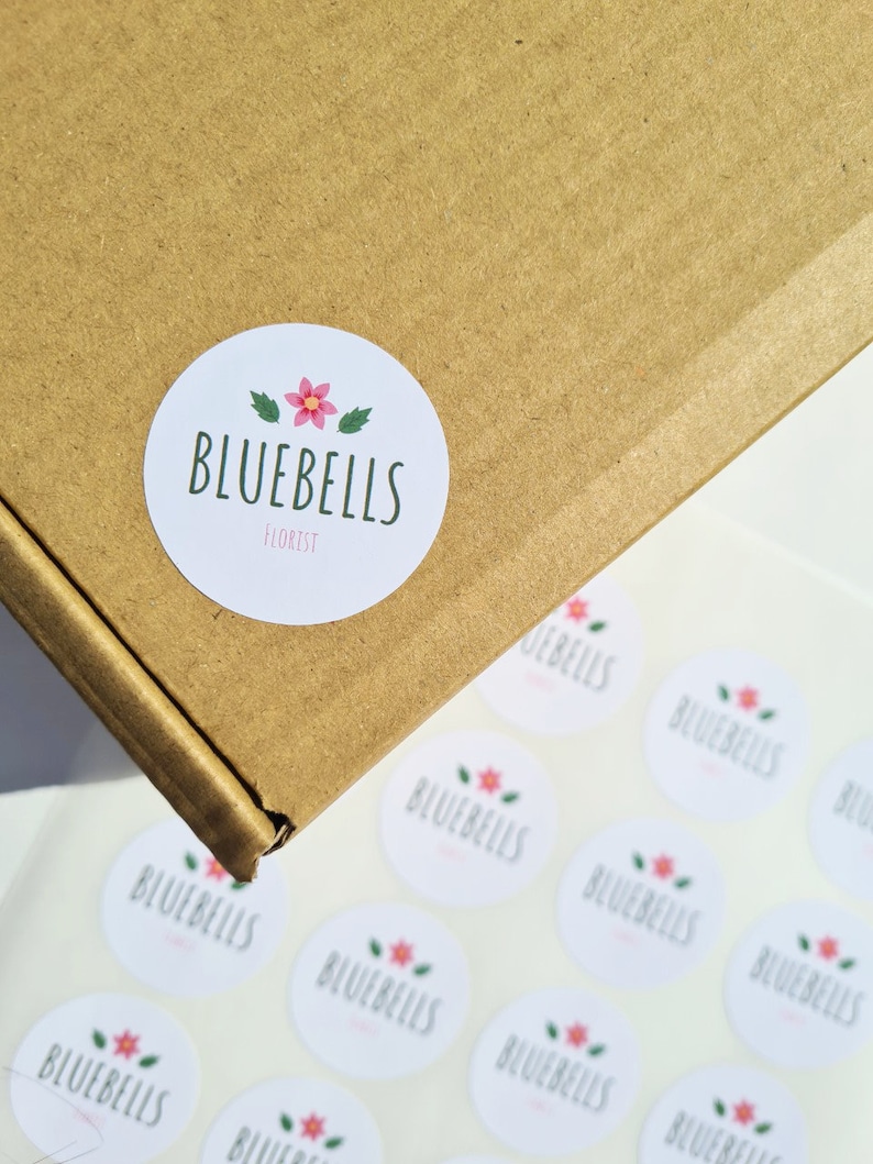 May include: A sheet of white round stickers with a floral logo that says "Bluebells Florist".