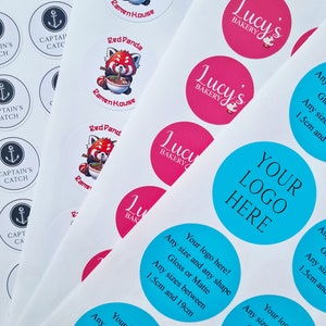 May include: Assortment of round stickers with various designs.  The stickers feature logos for businesses such as "Captain's Catch", "Ramen House", "Lucy's Bakery", and "Your Logo Here".  The stickers are available in a variety of colors, including blue, pink, and red.  The stickers are available in a variety of sizes, from 1.5 cm to 19 cm.