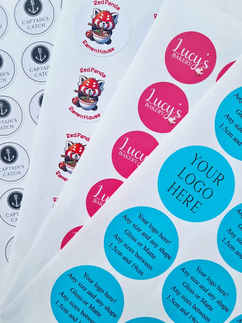 May include: Assortment of round stickers with various designs.  The stickers feature logos for businesses such as "Captain's Catch", "Ramen House", "Lucy's Bakery", and "Your Logo Here".  The stickers are available in a variety of colors, including blue, pink, and red.  The stickers are available in a variety of sizes, from 1.5 cm to 19 cm.