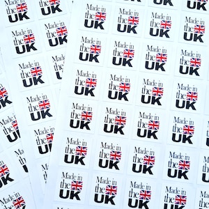 May include: A sheet of white paper with multiple stickers that say "Made in the UK" in black text with a red, white, and blue UK flag.