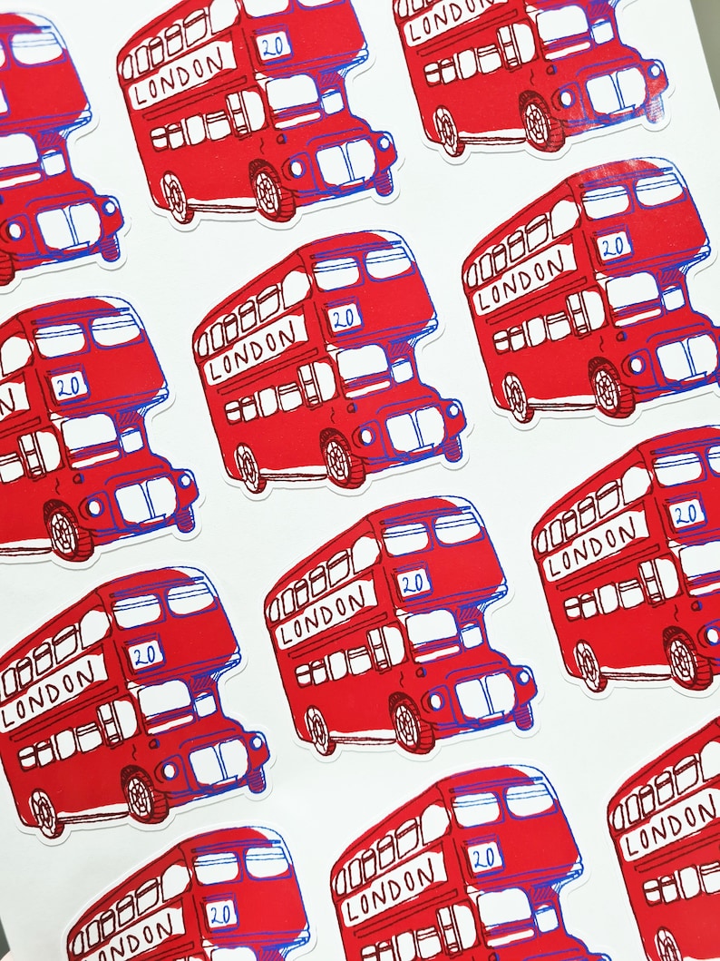 May include: Multiple red double-decker bus stickers with the word "LONDON" and the number "20" printed on them. The stickers are on a white background.