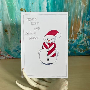 Winterliche Postkarte mit Schneemann zu Weihnachten