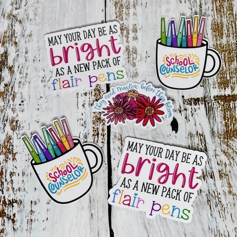 May include: Four colorful stickers with the text "May your day be as bright as a new pack of flair pens" and "School Counselor" with a mug and colorful pens inside. One sticker has a floral design with the text "They need Maslow before they bloom."