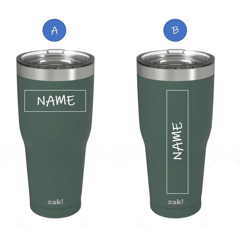 May include: Two green insulated tumblers with stainless steel lids. The tumblers have a white rectangle with the word "NAME" written inside. The tumblers are labeled "zak!" at the bottom.