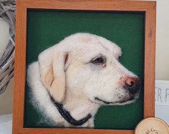 May include: A framed felted portrait of a Labrador Retriever dog. The dog is cream-colored with a black collar, set against a green background. The frame is made of wood. The dog's face is detailed with a realistic expression.
