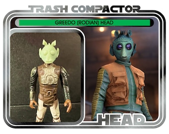 May include: Vintage "Trash Compactor" Greedo (Rodian) Head action figure. The figure is green, brown, and tan, with the text "GREEDO (RODIAN) HEAD" and "HEAD" on the packaging. The packaging also includes the text "Ages 14 and up".