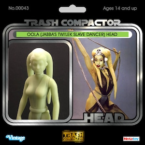 May include: Vintage "Trash Compactor" action figure packaging featuring a green Oola head figure and a photo of Oola. The packaging includes the text "OOLA (JABBA'S TWI'LEK SLAVE DANCER) HEAD" and "Ages 14 and up."