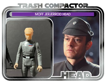 May include: A retro action figure package with a gray-uniformed figure and a portrait of a man in a cap. The package is labelled "TRASH COMPACTOR" and "MOFF JERJERROD HEAD". The figure wears a gray uniform with a black belt and a light-colored head.