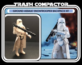 May include: Vintage "Trash Compactor" Ground Assault Snowtrooper Backpack Kit action figure. The figure is white and beige, holding a black weapon. The packaging includes the text "Ages 14 and up."