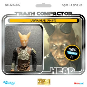 May include: Vintage action figure card featuring a Labria Head (Pin Fit) figure. The card has a yellow and black design with the text "TRASH COMPACTOR" and "Ages 14 and up." The figure is a light tan color with a detailed chest piece.