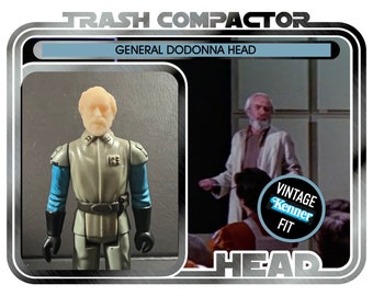 May include: Vintage General Dodonna Head action figure from the Trash Compactor series. The figure is dressed in a grey uniform with blue sleeves and black gloves. The packaging includes the text "Vintage Kenner Fit."