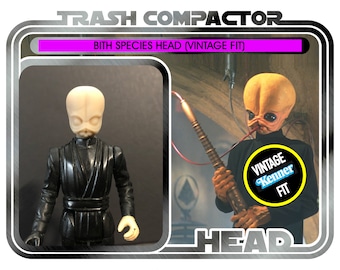 May include: Vintage "Trash Compactor" action figure featuring a Bith Species Head. The figure is black with a light-colored head. The packaging includes the text "Vintage Kenner Fit" and "Ages 14 and up."