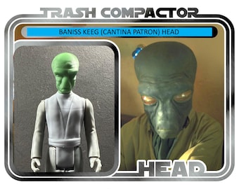 May include: A vintage "Trash Compactor" toy package with a green-skinned alien figure, labelled "Baniss Keeg (Cantina Patron) Head." The package shows two images of the alien and the text "Ages 14 and up."
