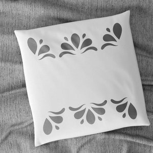 May include: White pillow with a grey floral design around the edges.