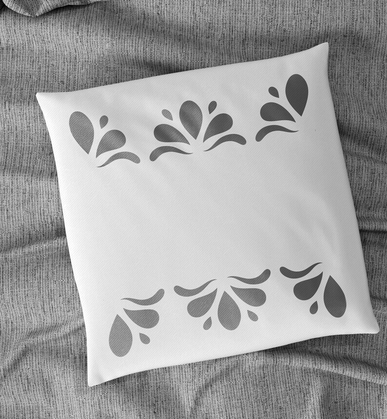 May include: White pillow with a grey floral design around the edges.