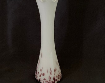 May include: A white glass vase with a scalloped rim and a speckled purple design.