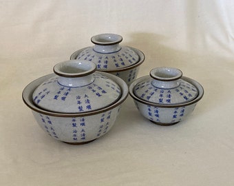Trio of Chinese lidded bowls with calligraphy on crackle glaze