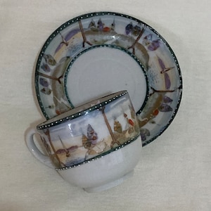 Vintage hand painted porcelain tea cup and saucer