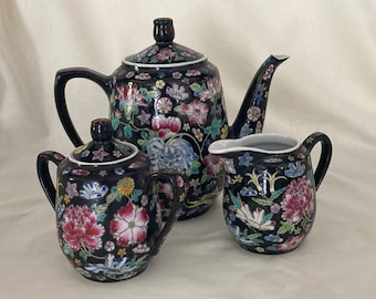 Chinese black Famille Noire porcelain teapot, creamer and sugar bowl set