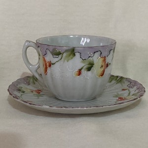 Vintage hand painted porcelain tea cup and saucer set