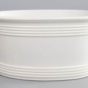 May include: A white ceramic oval planter with two curved handles. The planter has a series of horizontal ridges around the middle and bottom. The interior is smooth and the exterior is a matte white.