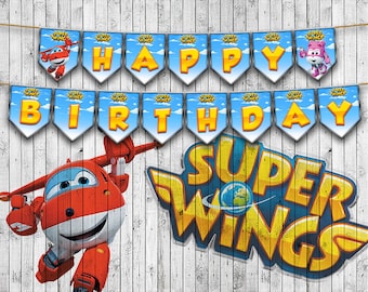 May include: A Super Wings birthday banner with blue and yellow letters spelling "Happy Birthday" and a red airplane character with a blue and white design. The banner has a blue background with white clouds and the words "Super Wings" in yellow letters.