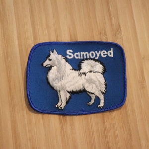 May include: Blue embroidered patch with a white Samoyed dog silhouette and the word "Samoyed" in white text.