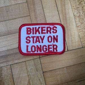 May include: Red and white embroidered patch with the text "Bikers Stay On Longer".