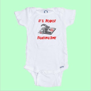 May include: A white baby grow with a red and black graphic of a robot fighting a toy. The text on the onesie reads "It's Robot Fighting Time".
