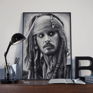 May include: Black and white pencil drawing of a man with long dreadlocks, wearing a bandana and a necklace. The drawing is framed and hanging on a wall.