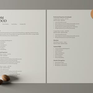 Op de afbeelding: Een cv-sjabloon van twee pagina's met de naam "TOM WOOD" bovenaan. Het cv bevat secties voor samenvatting, vaardigheden, professionele ervaring, opleiding en technische vaardigheden. Twee decoratieve houten objecten staan ​​onderaan.