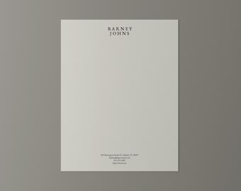 May include: A cream-colored sheet of paper with the text "BARNEY JOHNS" in black at the top. Additional black text at the bottom includes an address, phone number, and website.